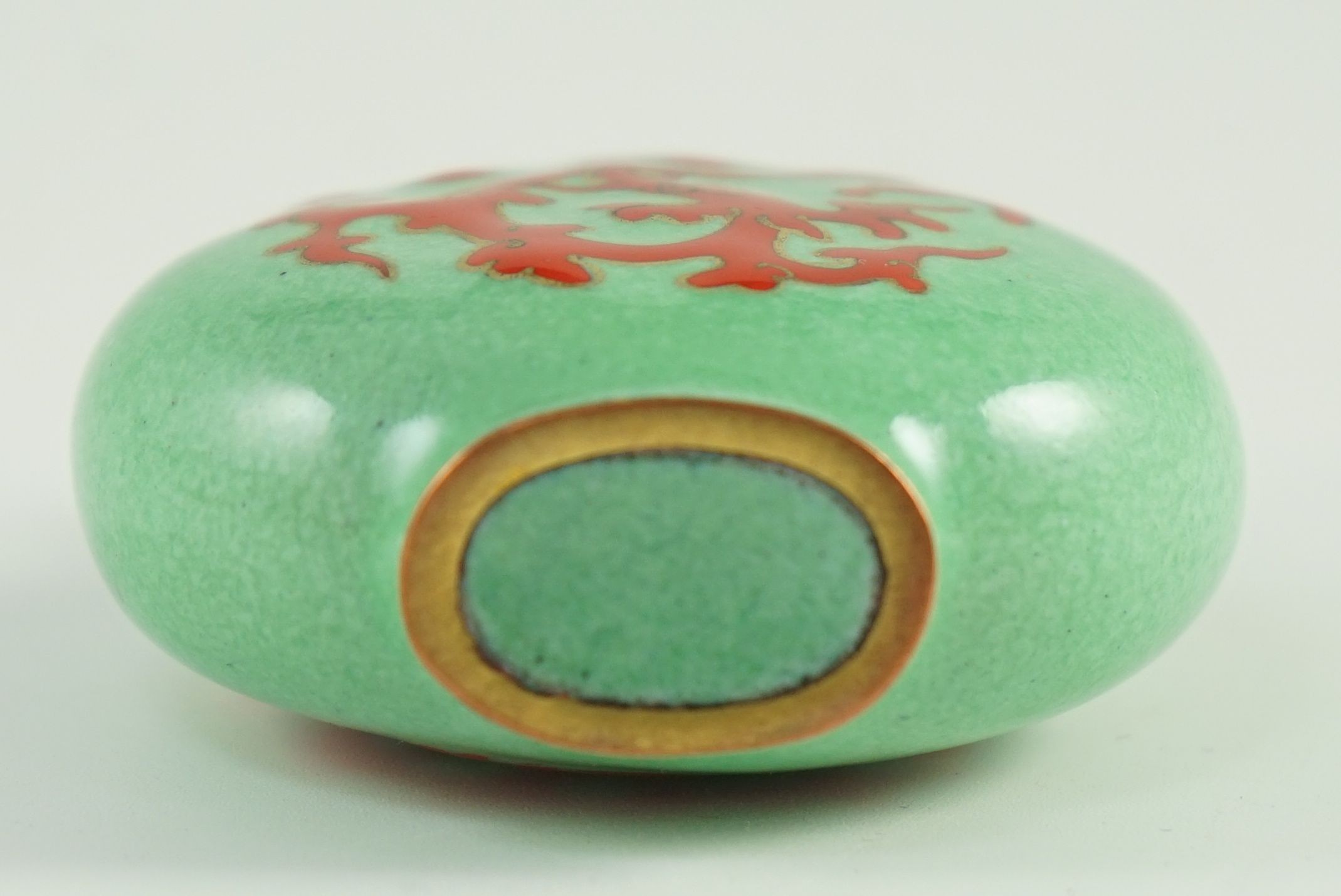 A Chinese enamel on copper green ground snuff bottle, 19th/20th century, 6.2 cm high including stopper